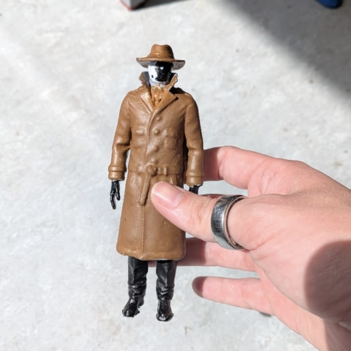 3D printed character figure held in hand