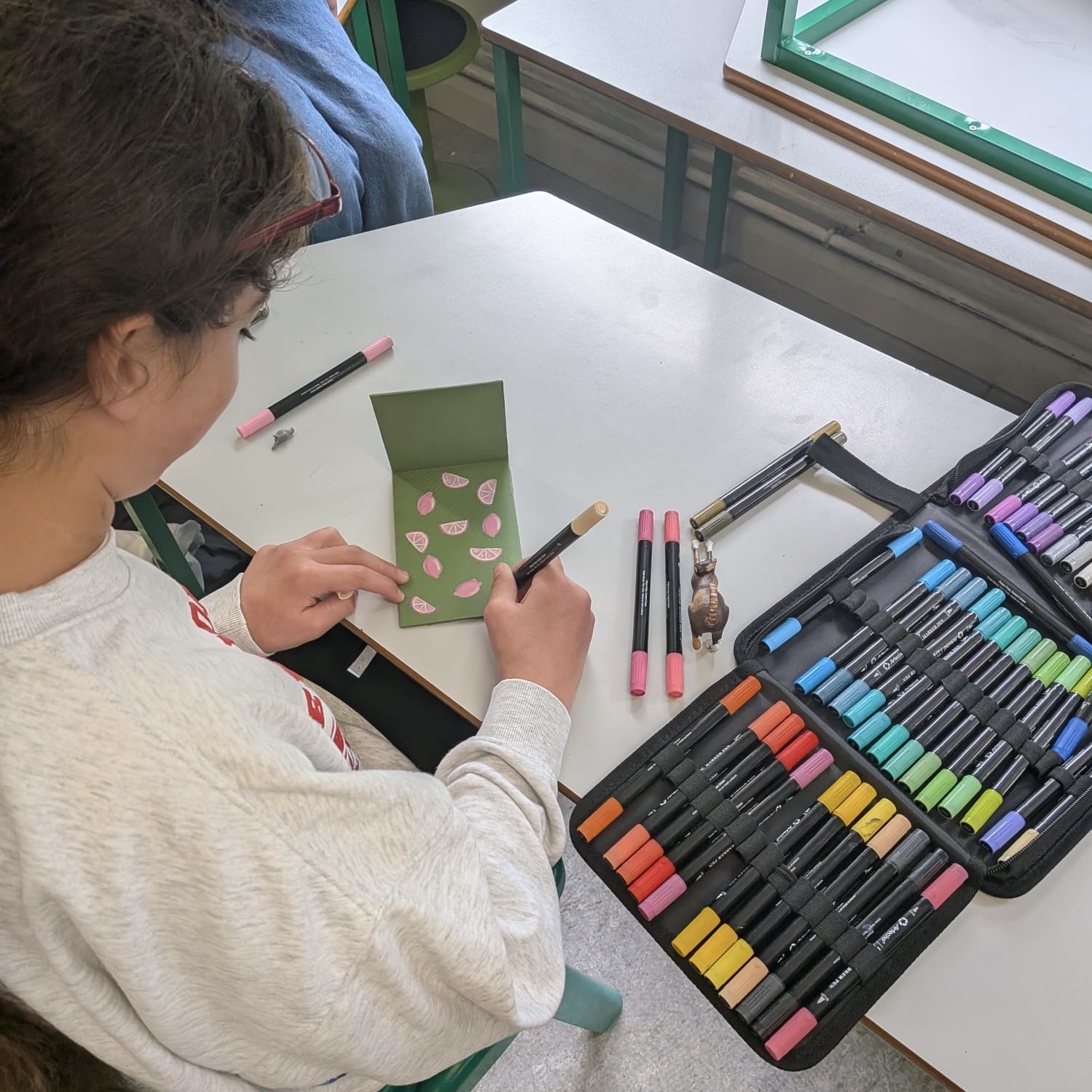 Student drawing with coloured pens